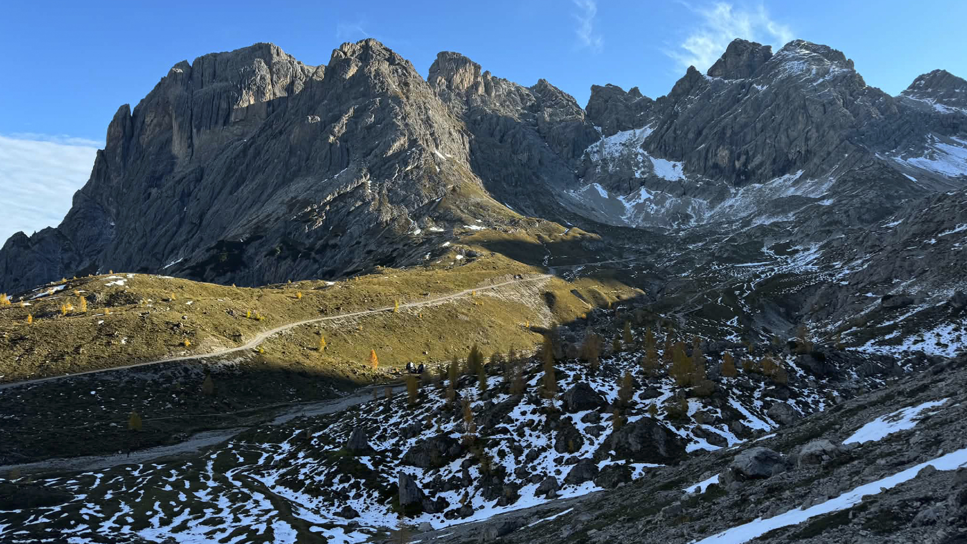 The mountain location: a road winding beneath jagged peaks in first light.
