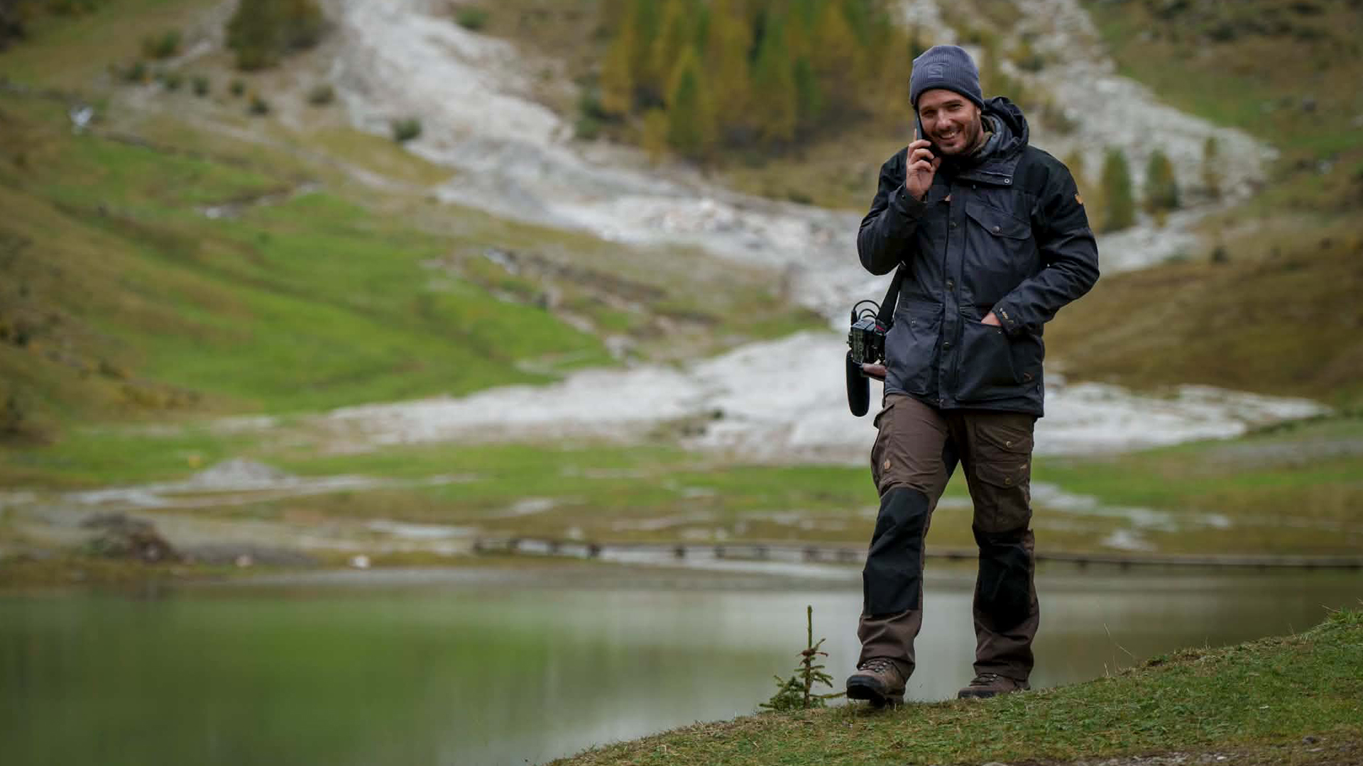 A call from the lakeside location, audio recorder slung over the shoulder.
