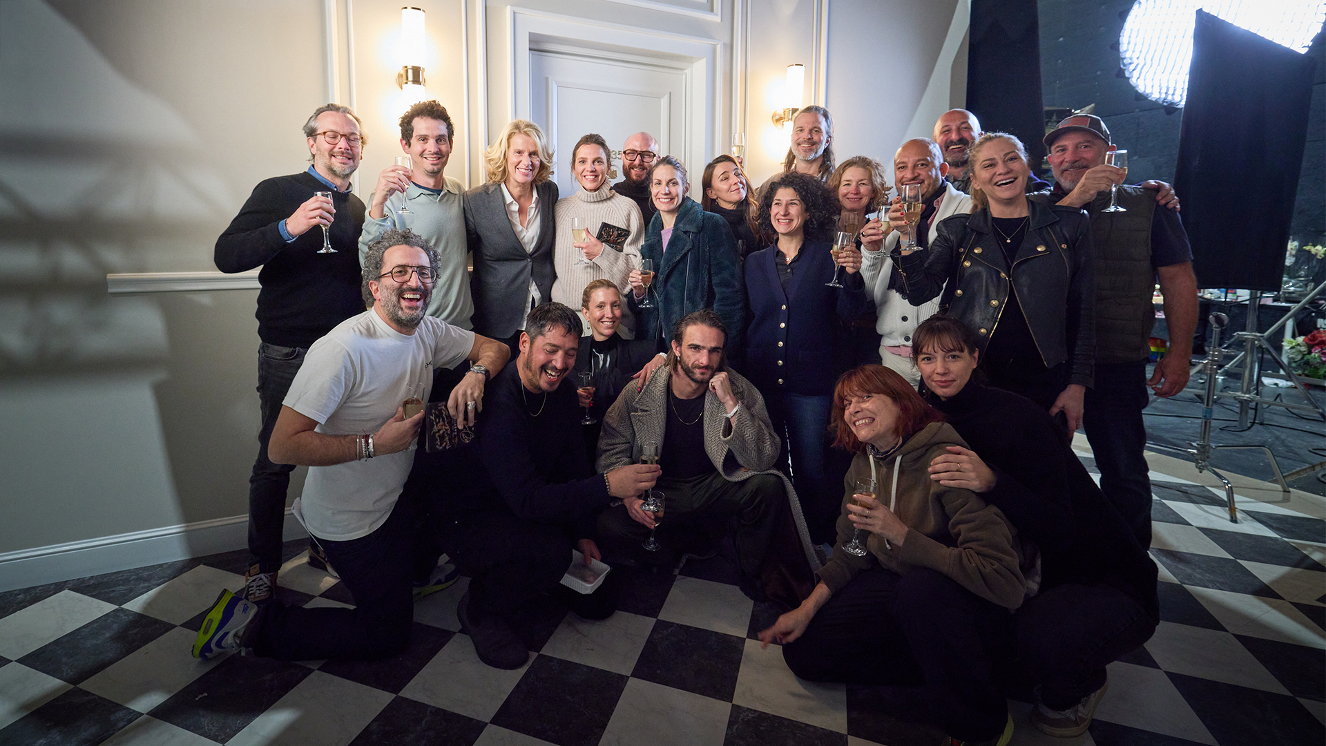 Cast and crew raise a glass at the wrap of the shoot.